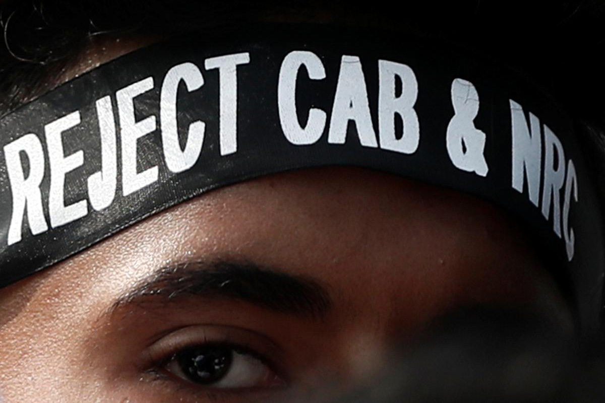 A man wearing a headband attends a protest against a new citizenship law, on the outskirts of Mumbai, India, on 20 December 2019.