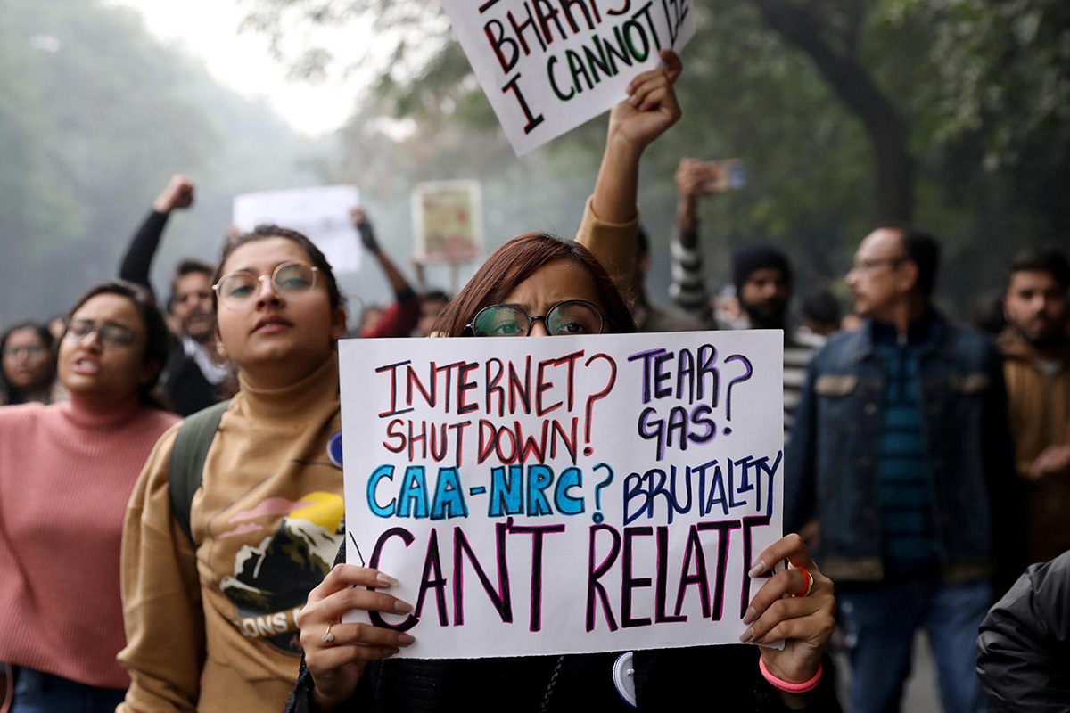 Demonstrator display placards and shout slogans during a protest against a new citizenship law, in New Delhi, India, on 19 December 2019.
