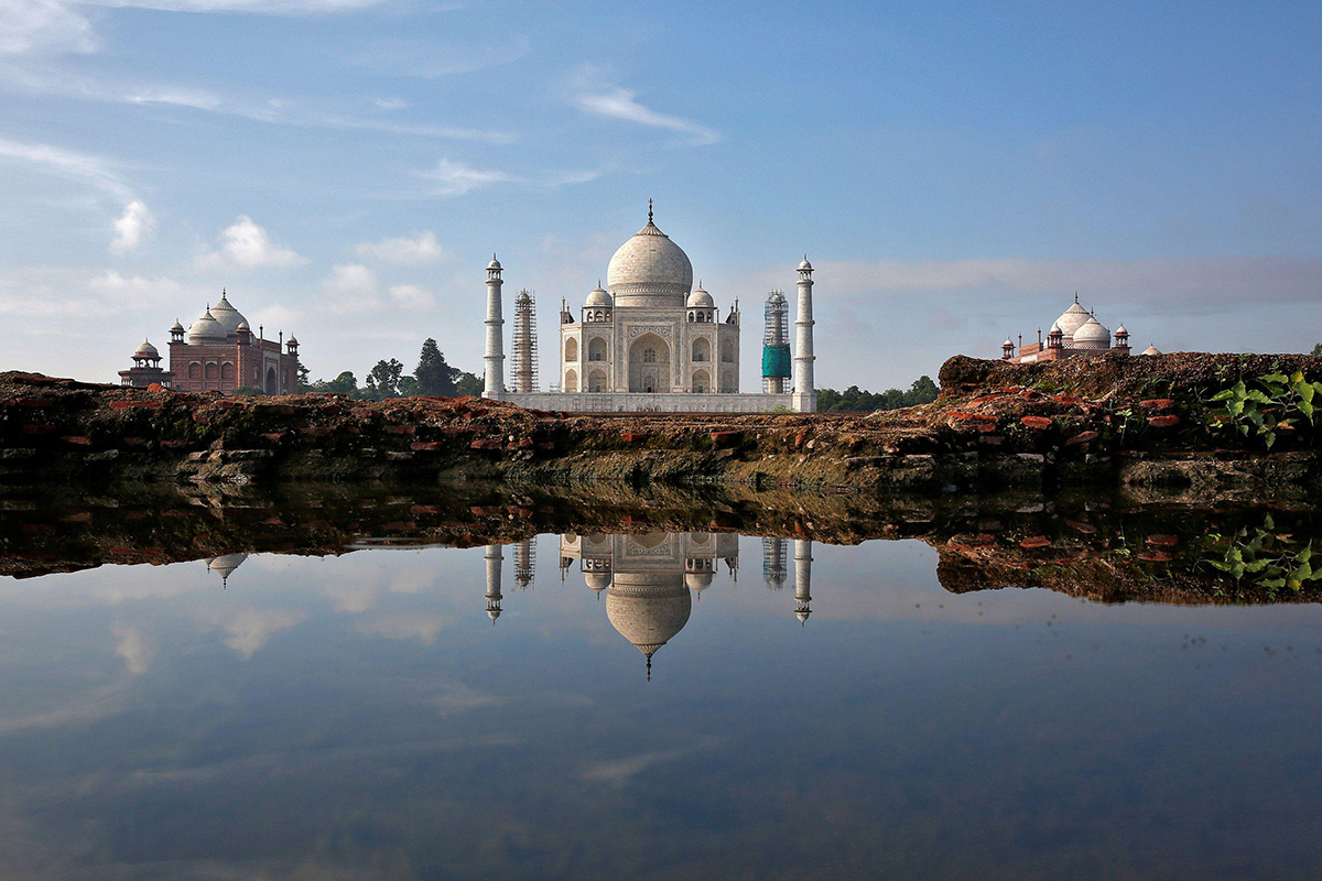 The Taj Mahal is reflected in a puddle in Agra, India, on 9 August 2016.