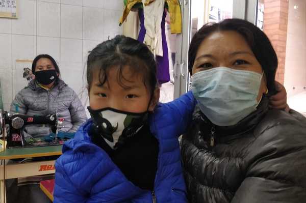 Exile Tibetans wearing masks to protect from coronavirus, at a tailoring centre in McLeod Ganj, India, on 6 March 2020.