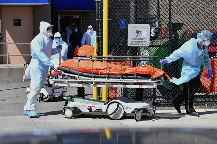 Medical staff move bodies from the Wyckoff Heights Medical Center to a refrigerated truck in Brooklyn, New York.