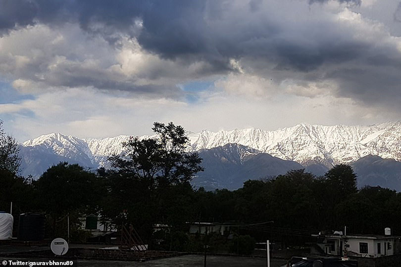 The snowy mountain rang can be seen clearly among billowing clouds as the India's pollution levels drop.