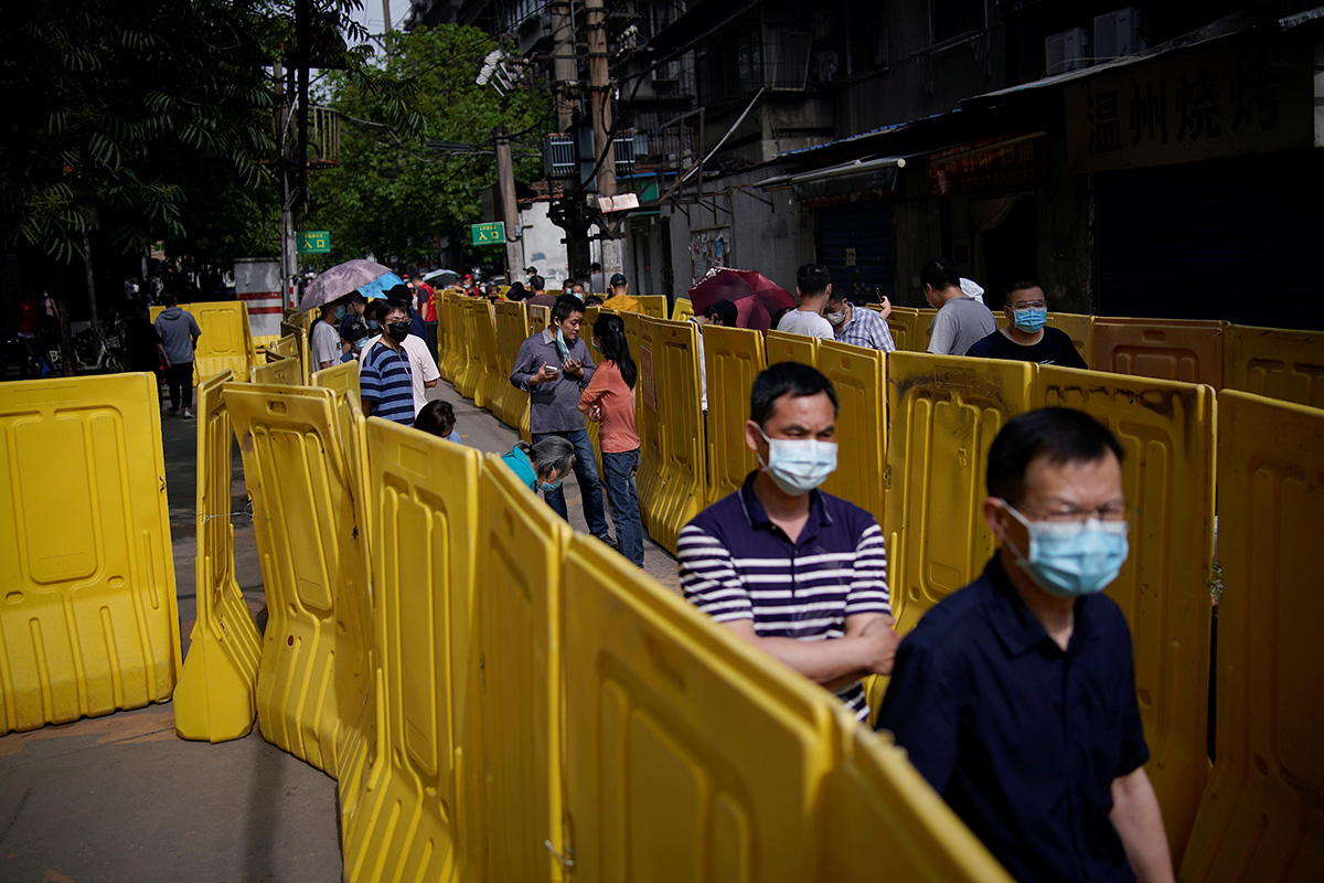 Residents wearing face masks line up for nucleic acid testings at a residential compound in Wuhan, the Chinese city hit hardest by the coronavirus disease (COVID-19) outbreak, Hubei province, China, on 17 May 2020.