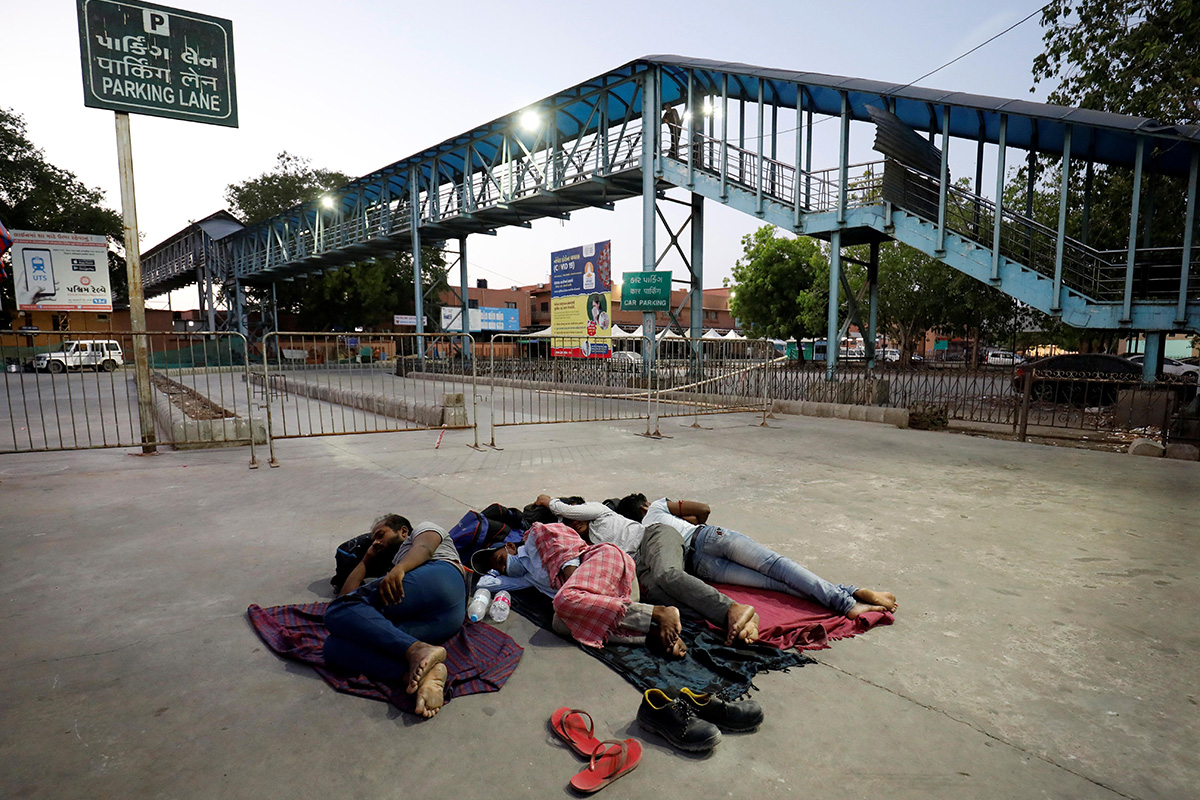 Migrant workers sleep outside a railway station during an extended lockdown to slow the spread of the coronavirus disease (COVID-19), in Ahmedabad, India, on 17 May 2020.
