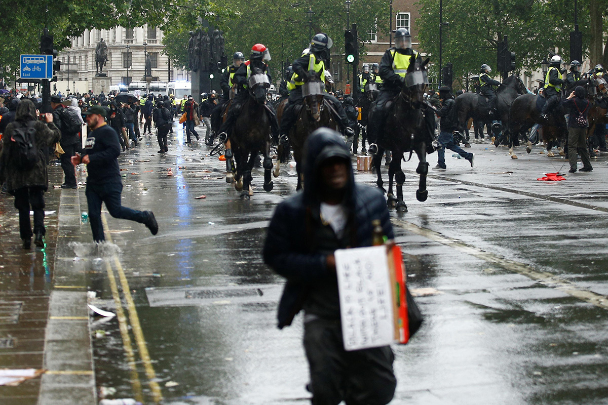 Police officers on horses are seen as police clash with demonstrators during a Black Lives Matter protest near Downing street in London, following the death of George Floyd who died in police custody in Minneapolis, London, Britain, on 6 June 2020.