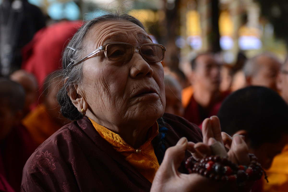Adhe Tapontsang aka Ama Adhe prays during a Dalai Lama teaching at Tsuglakhang Temple in McLeod Ganj, India, on 5 March 2015.