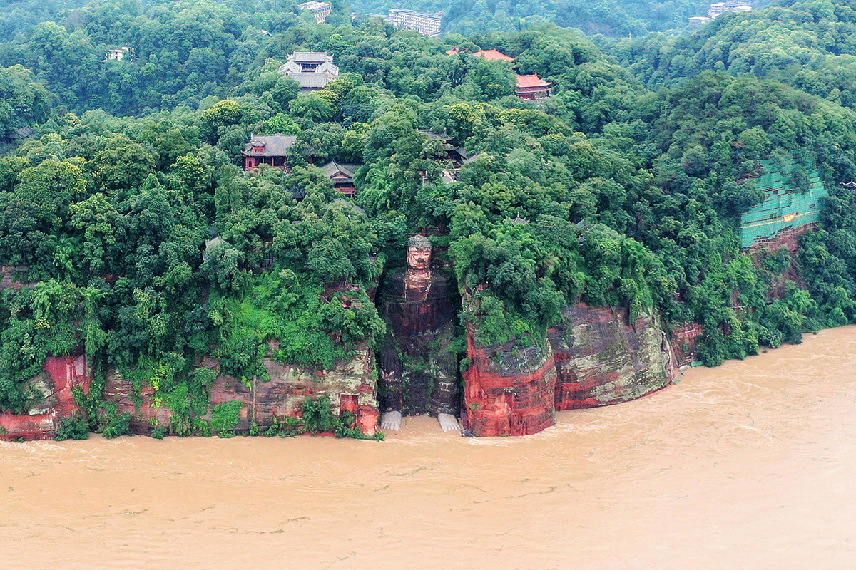 State media footage showed murky floodwaters lapping at the feet of the 71m metre-tall Leshan Giant Buddha in Sichuan - for the first time since the People's Republic of China was founded in 1949.