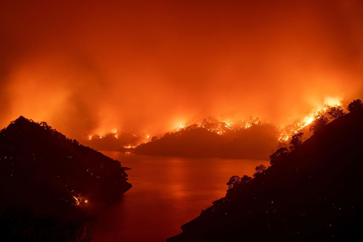 Flames surround Lake Berryessa during the LNU Lightning Complex fire in Napa, California, US, on 19 August 2020.