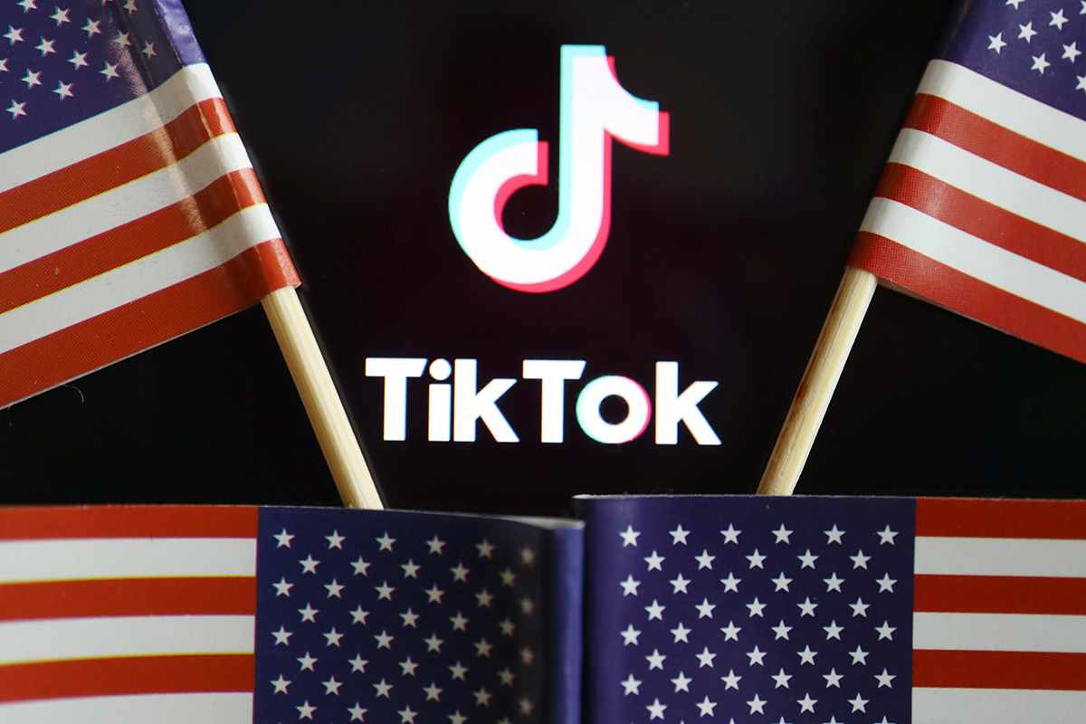 US flags are seen near a TikTok logo in this illustration picture taken on 16 July 2020.