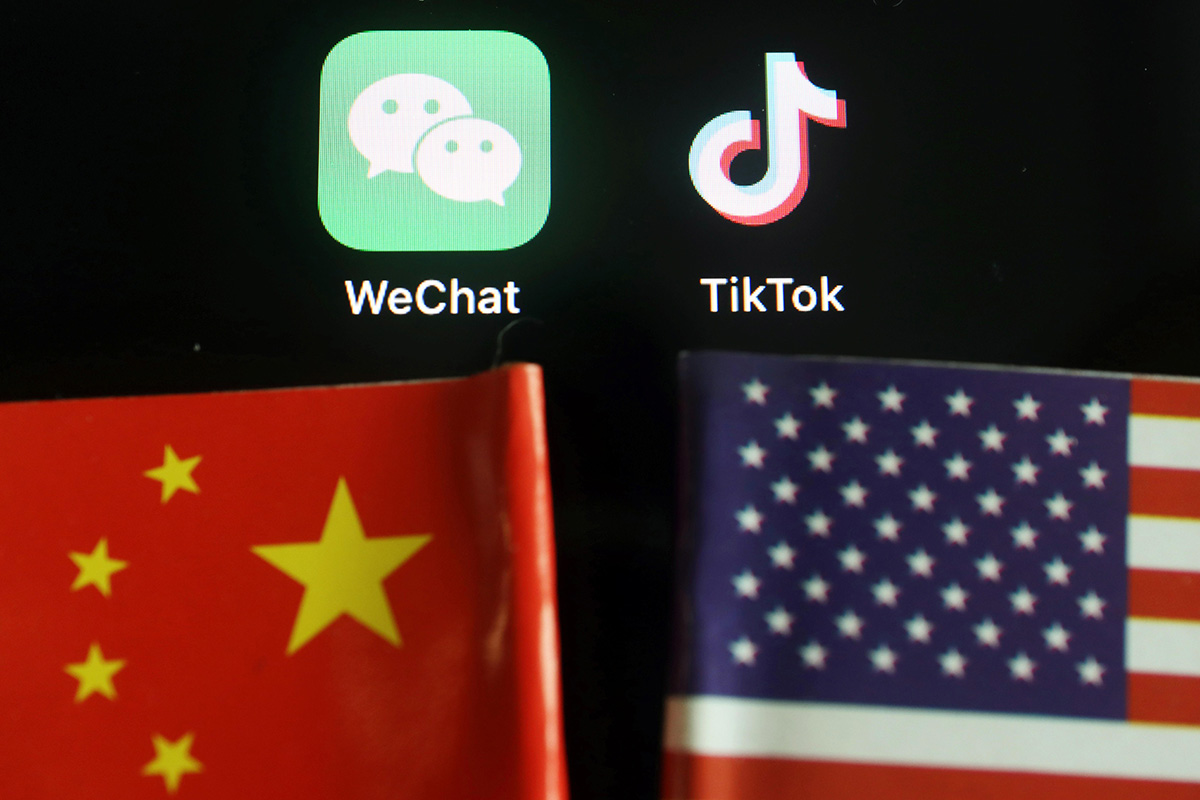 The messenger app WeChat and short-video app TikTok are seen near China and US flags in this illustration picture taken on 7 August 2020.
