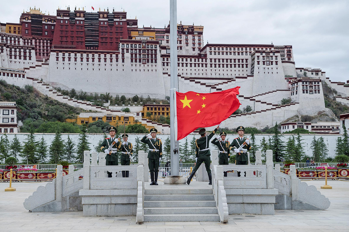 The Chinese national flag is raised during a ceremony marking the 96th anniversary of the founding of the Communist Party of China (CPC) at Potala Palace in Lhasa, Tibet Autonomous Region, China, on 1 July 2017.
