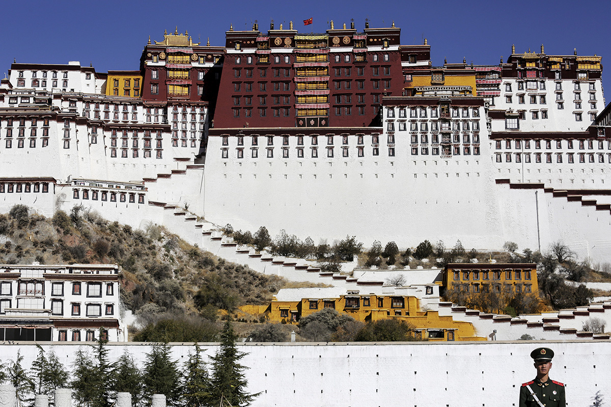 A paramilitary policeman stands guard in front of the Potala Palace in Lhasa, Tibet Autonomous Region, China, on 17 November 2015.