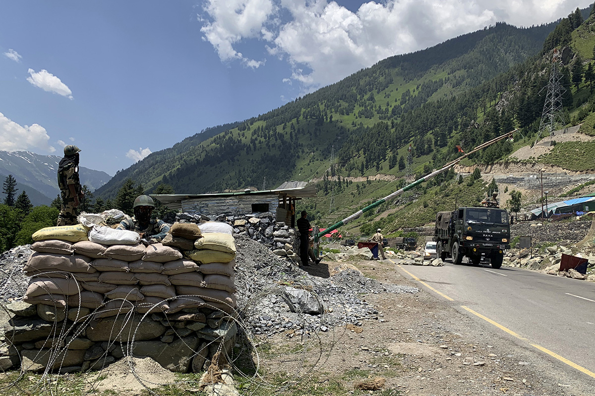 Indian soldiers keep guard as an army convoy moves on the Srinagar-Ladakh highway at Gagangeer, India on 18 June 2020.
