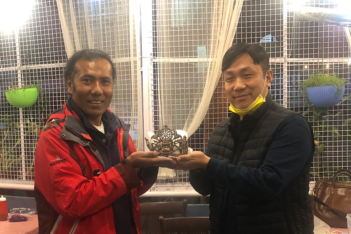 Founder and Director of the Miss Tibet Pageant Lobsang Wangyal (left) handing over the first and original Miss Tibet crown to Karma Kunsang of Snow Region Enterprises for his collection, at McLeod Ganj, India, on 28 November 2020.