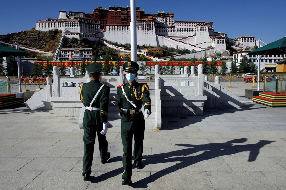 Paramilitary police officers swap positions during a change of guard in front of Potala Palace in Lhasa, during a government-organised tour of the Tibet Autonomous Region, China, on 15 October 2020.