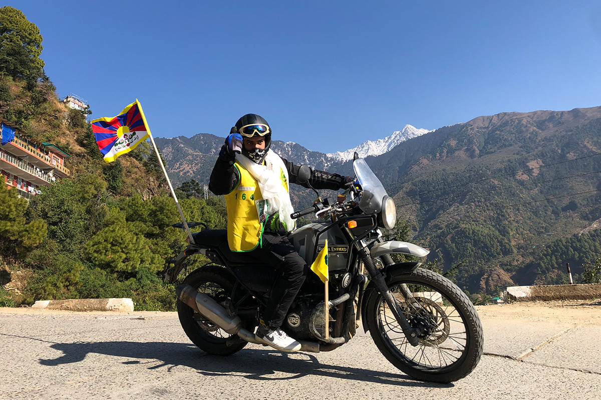 Indian supporter for Free Tibet Suresh from Manali joining the Tibetan Youth Congress motorcycle rally for Tibet waves as he leaves for the three-day long ride to Kinnaur on 18 November 2020. Suresh is among 55 TYC members taking part in the rally to highlight the Tibetan cause. 