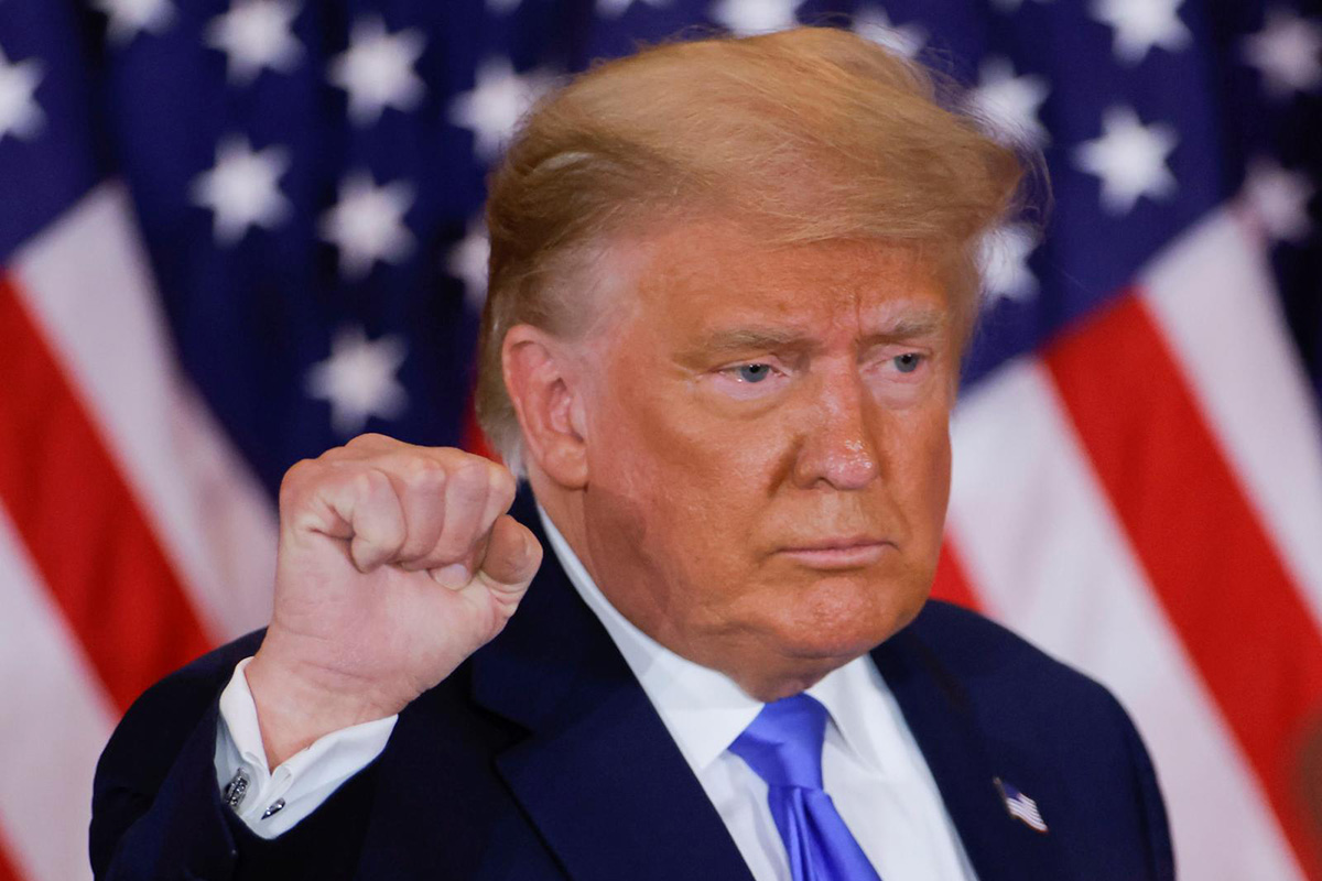 US President Donald Trump raises his fist as he reacts to early results from the 2020 US presidential election in the East Room of the White House in Washington, US, on 4 November 2020.