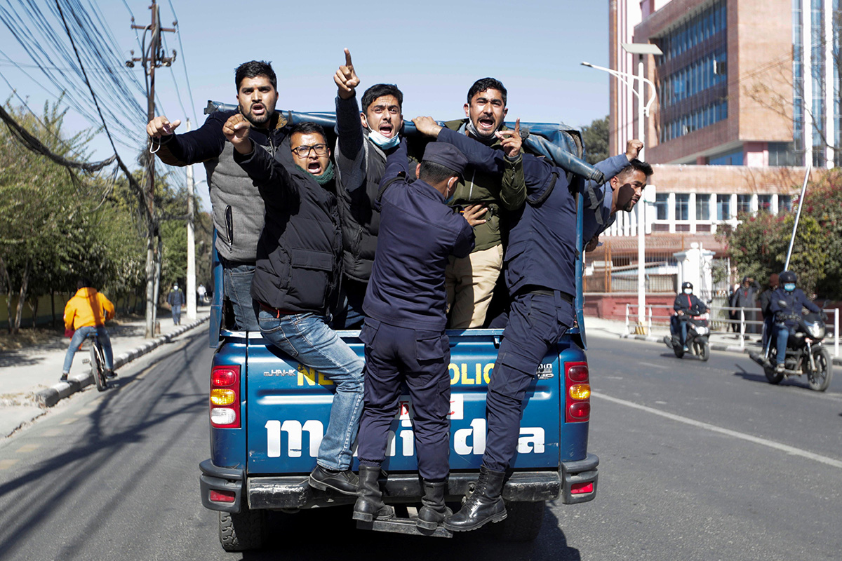 Protesters get detained in front of the supreme court as they take part in a protest after the parliament was dissolved and general elections were announced to be held in April and May, more than a year ahead of schedule, in Kathmandu, Nepal, on 25 December 2020.