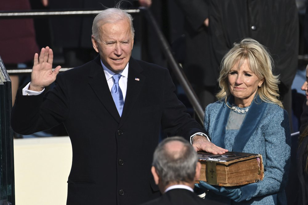 Joe Biden is sworn in as the 46th president of the United States by Chief Justice John Roberts as Jill Biden holds the Bible during the 59th Presidential Inauguration at the US Capitol in Washington, on 20 January 2021.