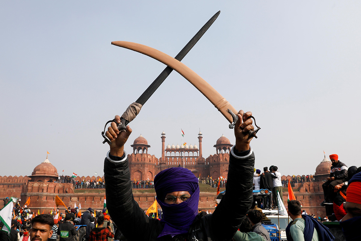A farmer holds a sword during a protest against farm laws introduced by the government, at the historic Red Fort in Delhi, India, on 26 January 2021.