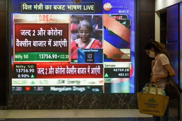 A screen shows Finance Minister Nirmala Sitharaman addressing parliament.