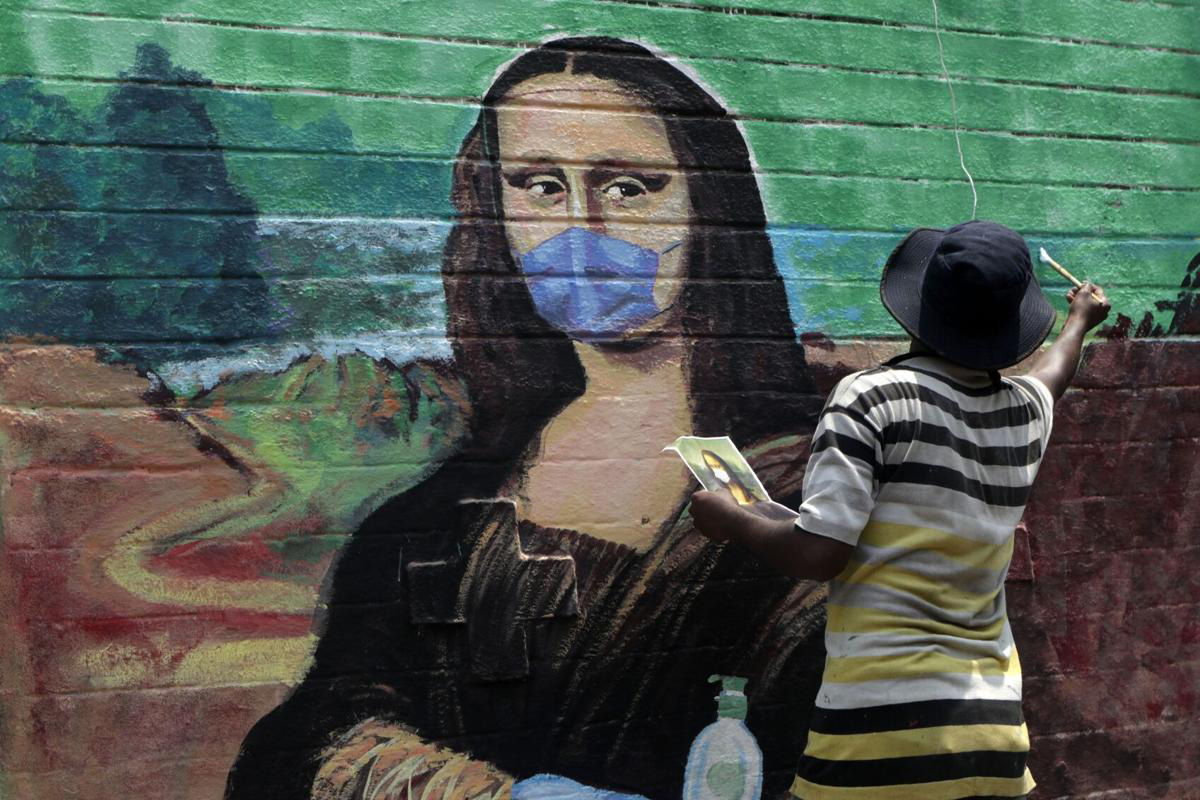 An artist makes a mural of the Monalisa wearing a face mask to spread awareness for the prevention of the coronavirus in Mumbai, India, on 24 March 2021.