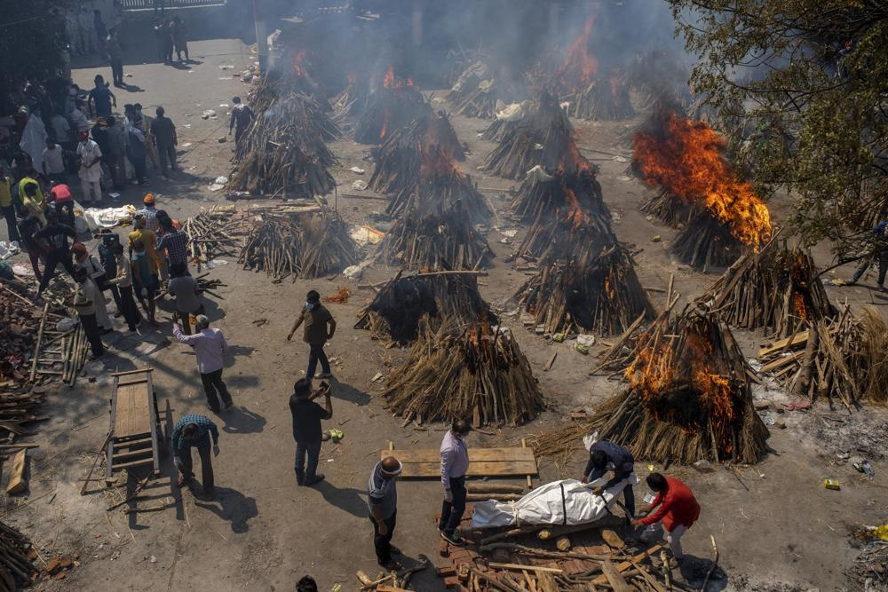 Multiple funeral pyres of victims of COVID-19 burn at a ground that has been converted into a crematorium for mass cremation in New Delhi, India, on 24 April 2021. Indian authorities are scrambling to get medical oxygen to hospitals where COVID-19 patients are suffocating from low supplies. The effort Saturday comes as the country with the world’s worst coronavirus surge set a new global daily record of infections for the third straight day. The 346,786 infections over the past day brought India’s total past 16 million.