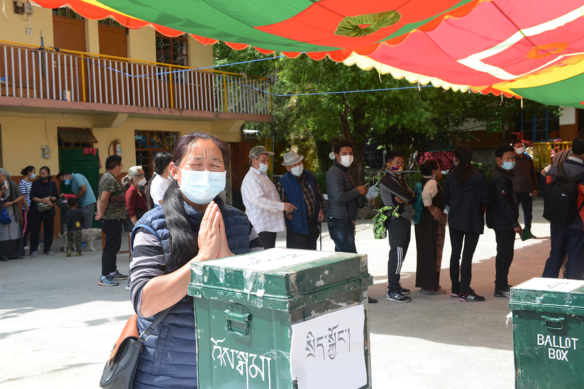 An exile Tibetan woman prays after casting her ballot to elect a new Sikyong, the political leader of the exile Tibetans, in McLeod Ganj, India, on 11 April 2021.