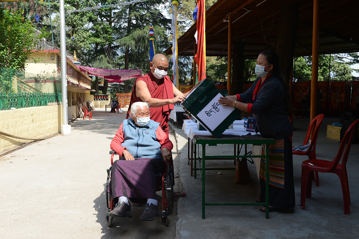 An elderly exile Tibetan woman Penam, 86, casts her vote to elect a new Sikyong or Tibetan political leader at a polling station in McLeod Ganj, India, on 11 April 2021.