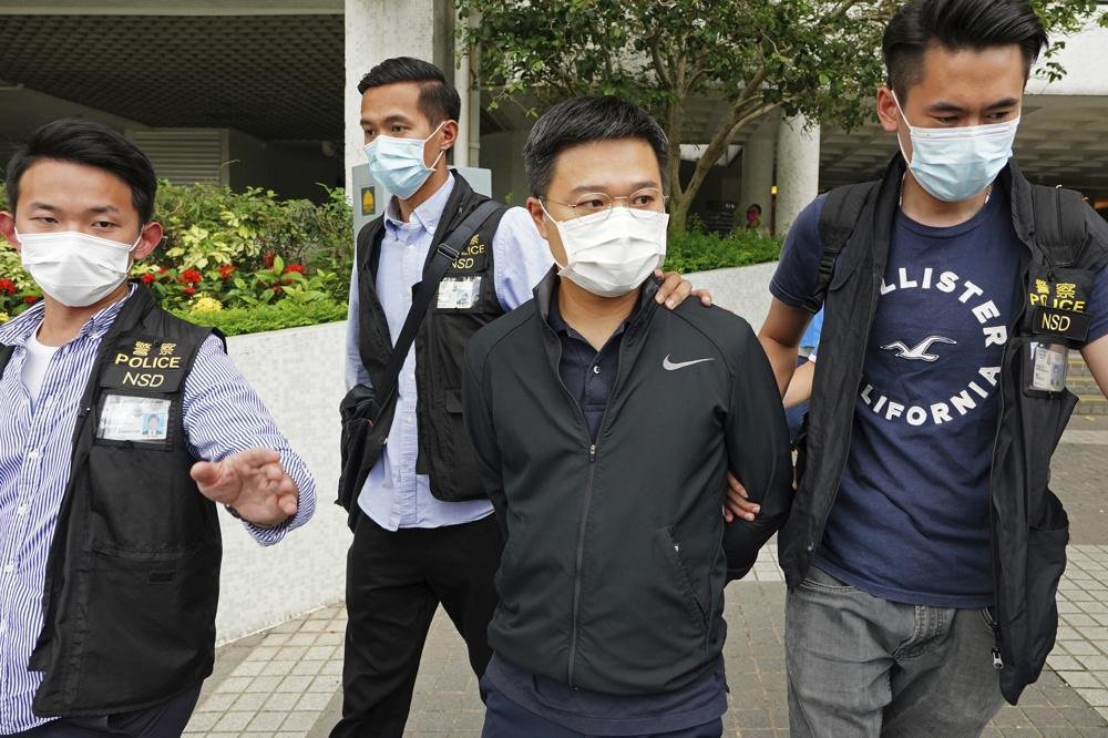 Ryan Law, second from right, Apple Daily's chief editor, is arrested by police officers in Hong Kong, on 17 June 2021. Hong Kong police on Thursday morning arrested the chief editor and four other senior executives of Apple Daily under the national security law on suspicion of collusion with a foreign country to endanger national security, according to local media reports. Local media, including the South China Morning Post and Apple Daily, reported Thursday that national security police arrested Apple Daily's chief editor Ryan Law.