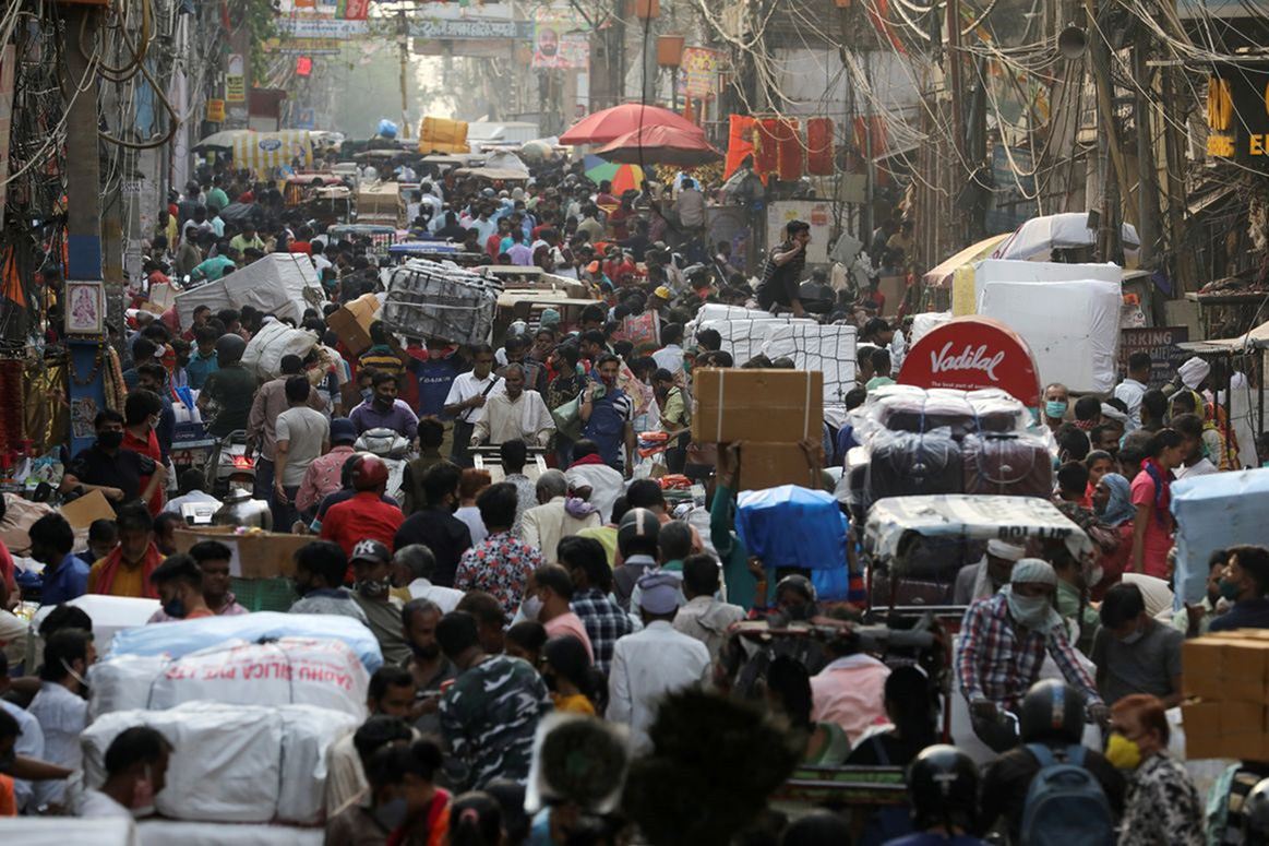 People walk at a crowded market amidst the spread of the coronavirus disease (COVID-19), in the old quarters of Delhi, India, on 6 April 2021.