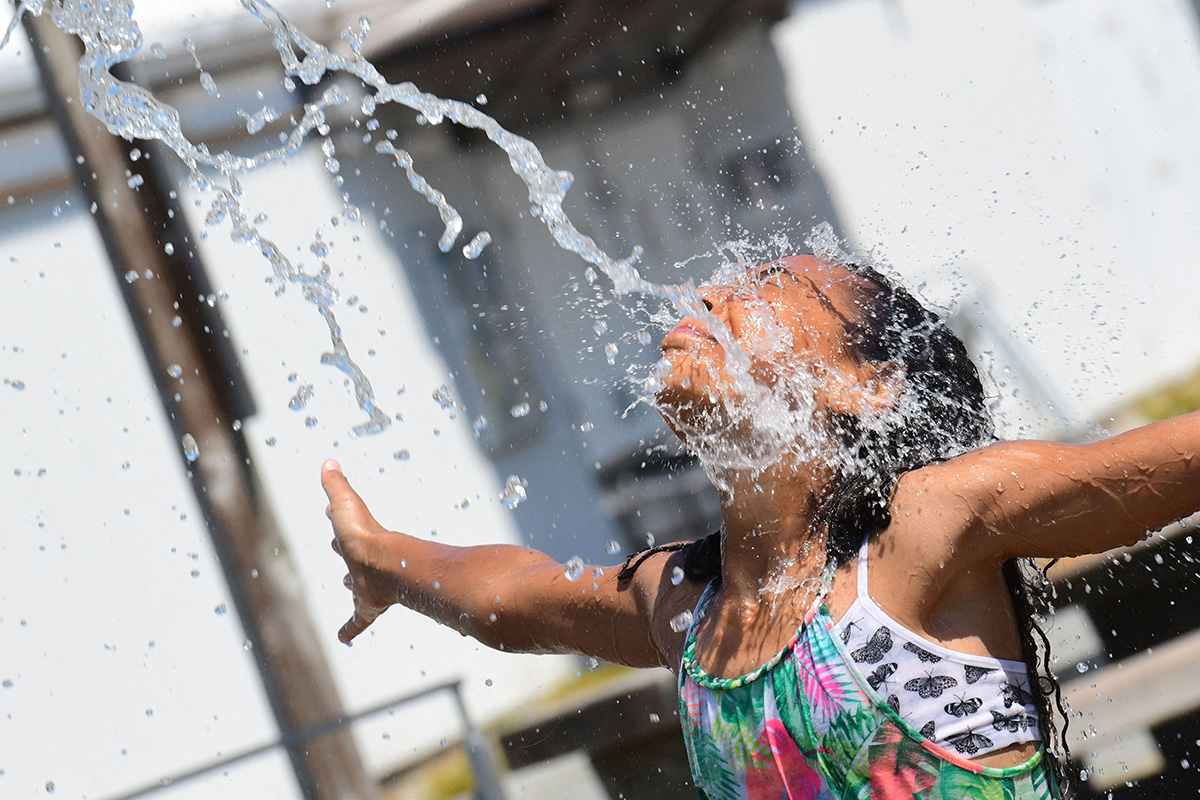 A child cools off at a community water park on a scorching hot day in Richmond, British Columbia.