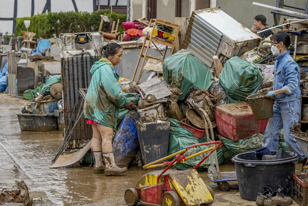 People clean their homes from mud and debris in Bad Neuenahr-Ahrweiler, Germany, on 17 July 2021. Due to strong rainfall, the Ahr river went over its banks and flooded big parts of the town.