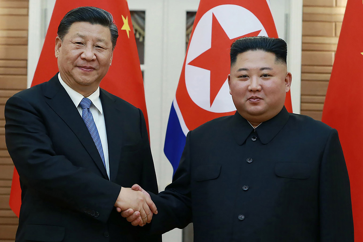 In this 20 June 2019 file photo provided by the North Korean government, North Korean leader Kim Jong-un, right, poses with Chinese President Xi Jinping for a photo at Kumsusan guest house in Pyongyang, North Korea. The North Korean and Chinese leaders expressed their desire on 11 July 2021 to further strengthen their ties as they exchanged messages marking the 60th anniversary of their countries’ defence treaty. In a message to Xi, Kim said it is “the fixed stand