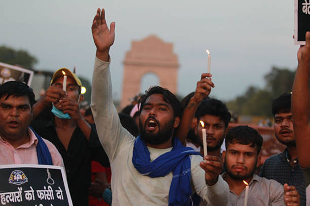 Activists of the Bheem Army stage a candle march protest against alleged rape and murder of a 9-year-old girl at India Gate in New Delhi, India, on 4 August 2021.
