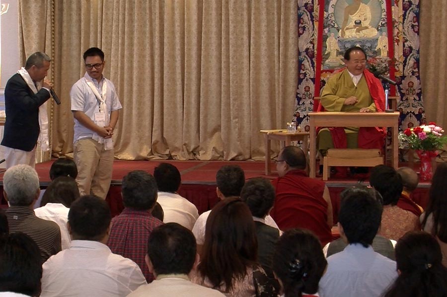 Tibetan Buddhist master Sogyal Rinpoche gestures as he is welcomed by Thupten Chakrishar and Sonam Sherpa (left) at a speaking event for the Tibetan and Himalayan Buddhist Community in New York City on 23 June 2012.