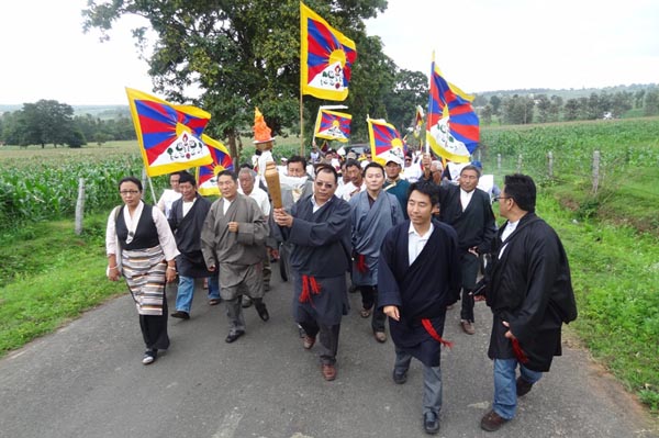 Exile Tibetans march with the 'Flame of Truth' torch relay in the Tibetan settlement of Bylakuppe on 20 July 2012.