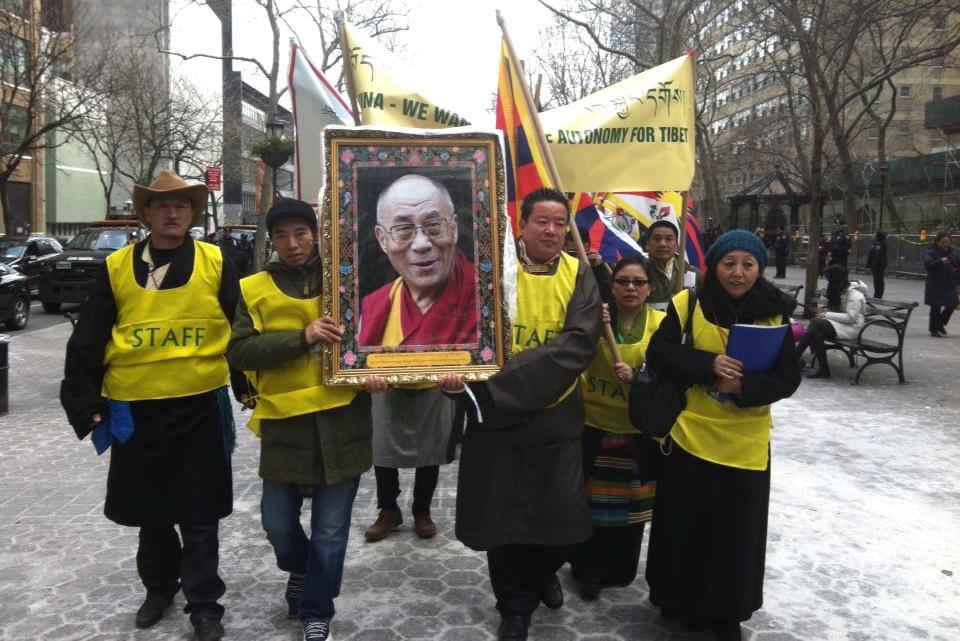 Members of the Regional Tibetan Youth Congress New York/New Jersey carry a portrait of the Dalai Lama.
