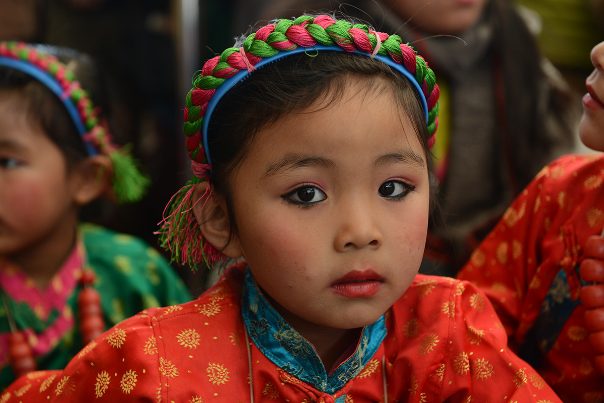 A girl child from Yongling kindergarten waits to perform on the occasion of the 30th anniversary of conferment of Nobel Peace Prize on Tibetan spiritual leader the Dalai Lama, at Tsuglakhang Temple in McLeod Ganj, India, on 10 December 2019.